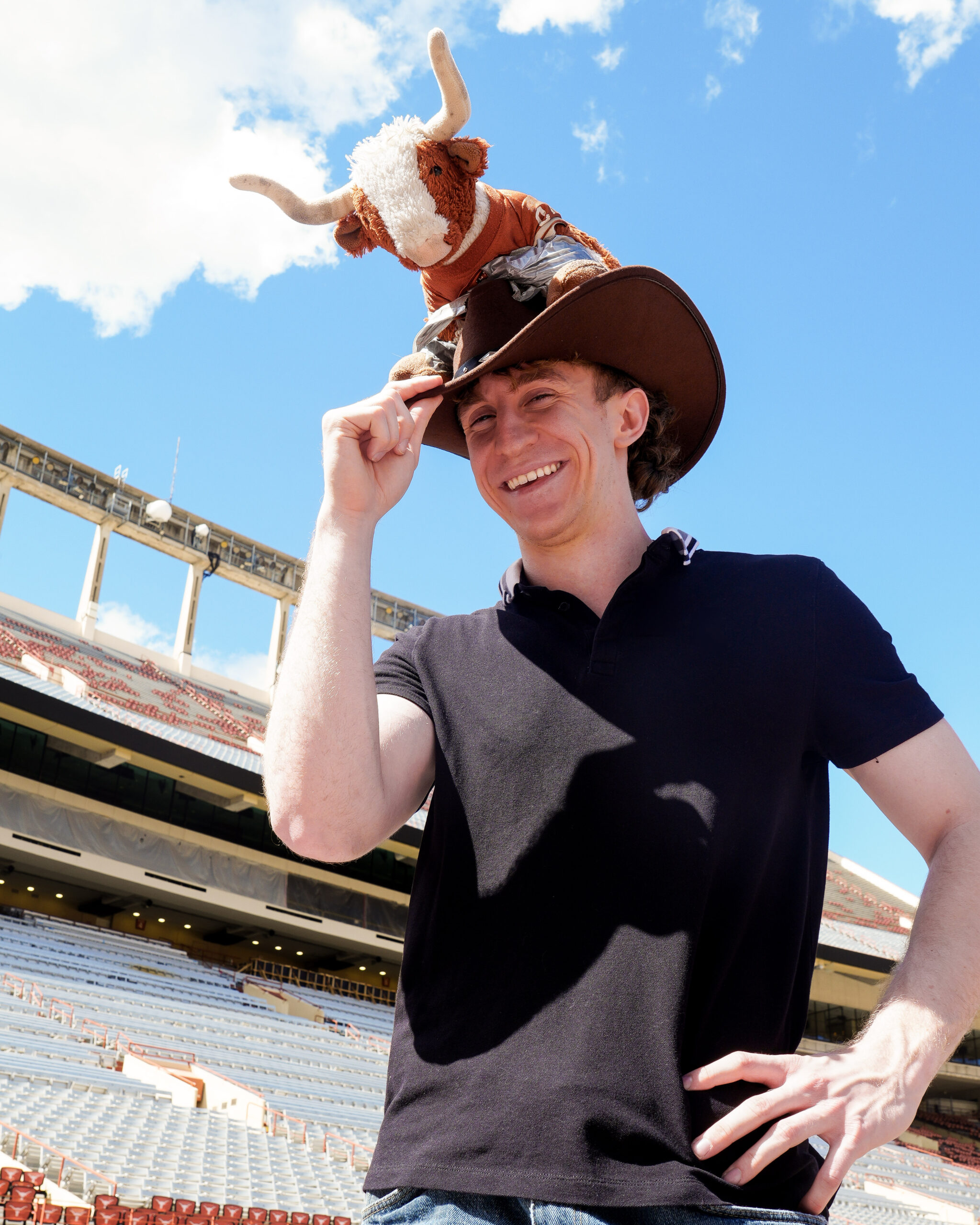 image of a student with a Bevo stuffed animal on a cowboy hat