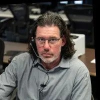 man wearing headset and grey shirt