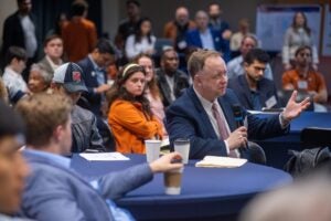 Man sitting at round table with microphone