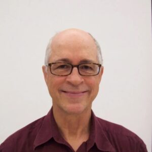 close up photo of man in maroon shirt