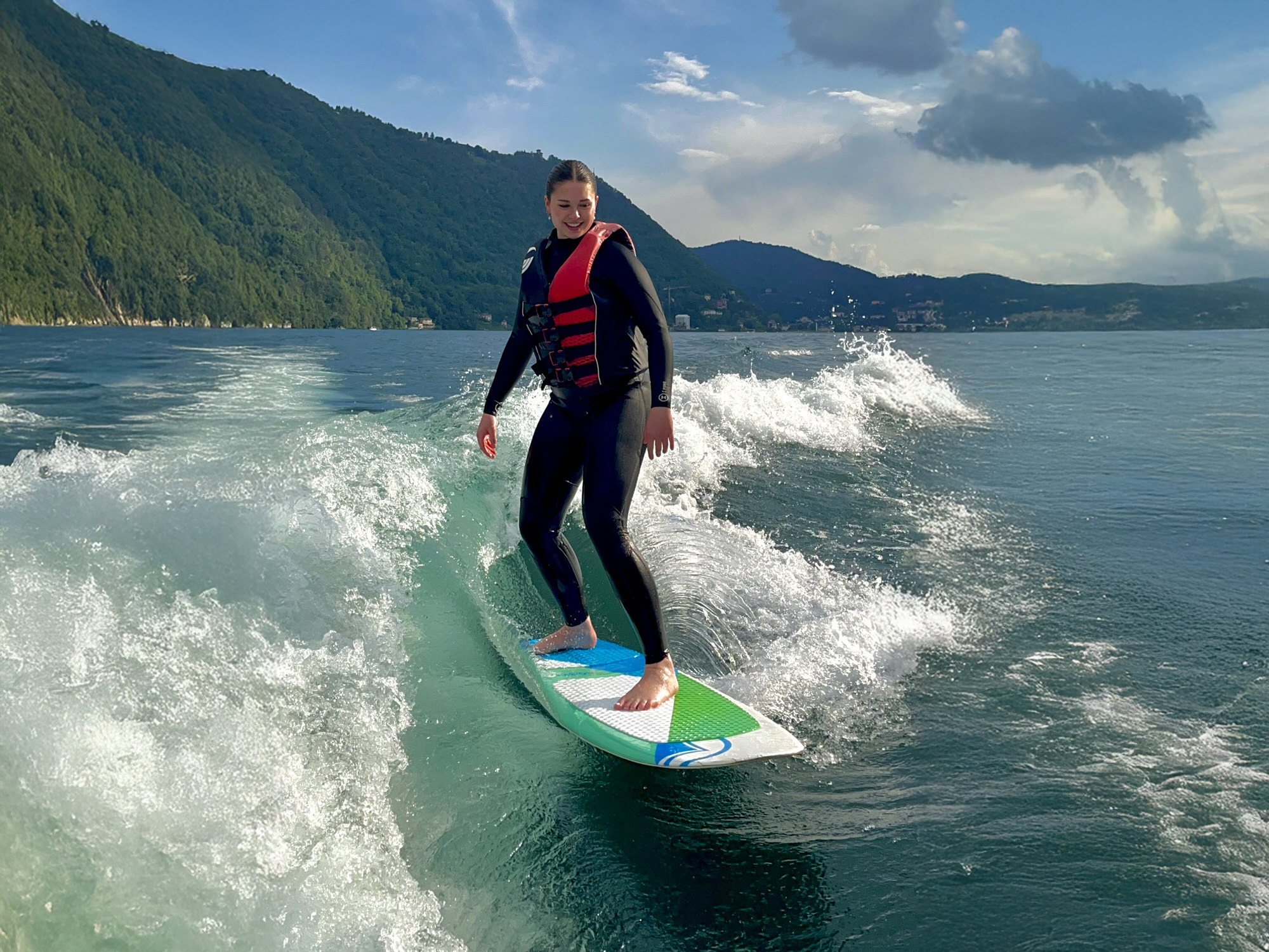 image of a woman wakesurfing on Lake Como