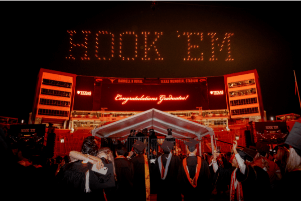 image at UT commencement with drones spelling out 