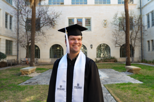 image of a man wearing a cap and gown in a courtyard
