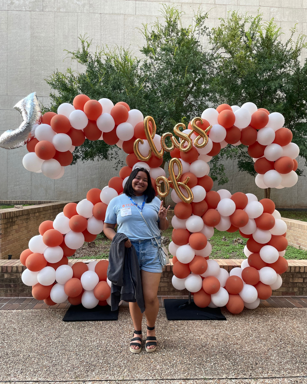 image of a woman standing in front of balloons of the number 26