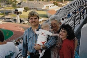 image of a family with a baby on the bleachers
