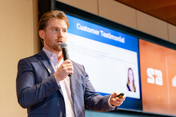 image of a man speaking with a microphone