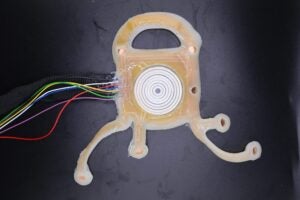 A patch with wires attached sits on a black table.