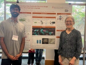 image of a student and his professor with a research poster