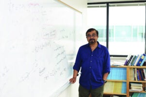 image of a professor next to a whiteboard