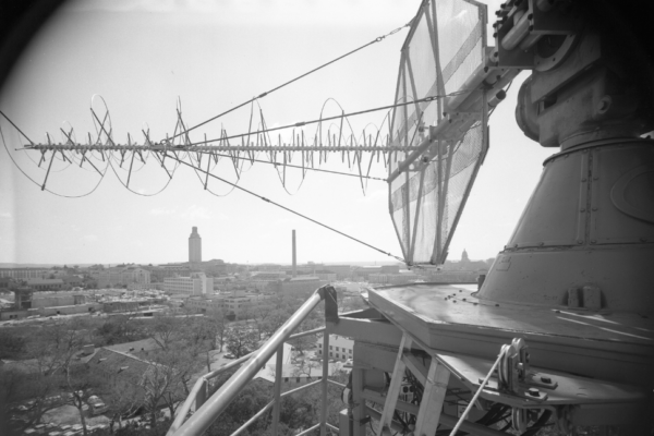 black and white photo looking at a satellite with the UT Tower in the background