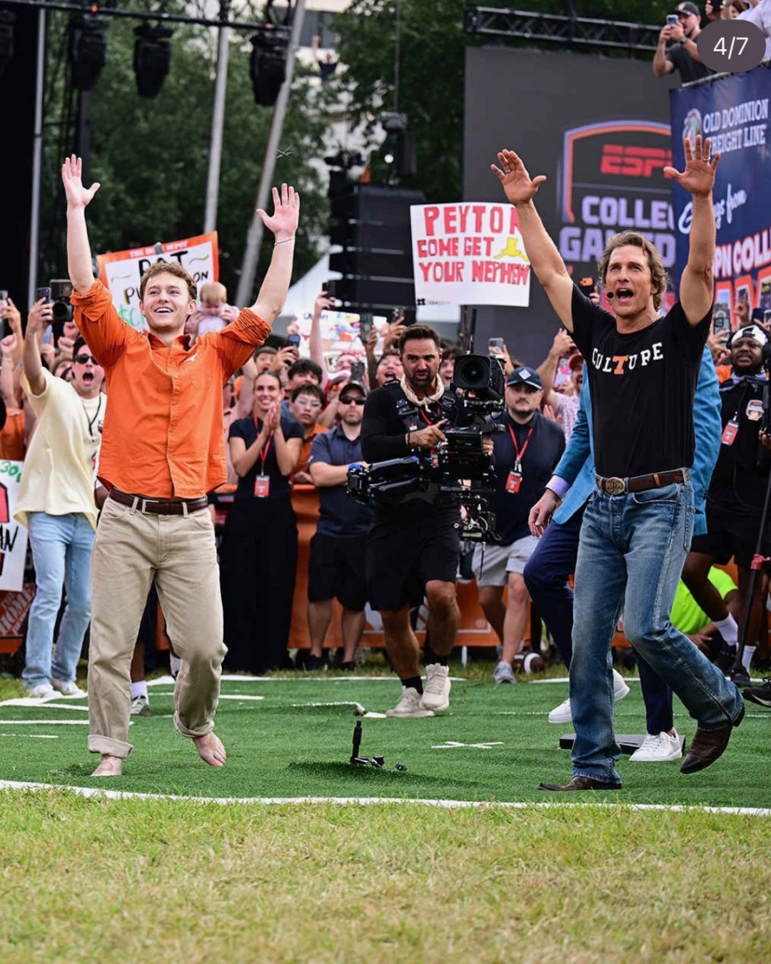 image of two people with their hands in the air in front of a crowd