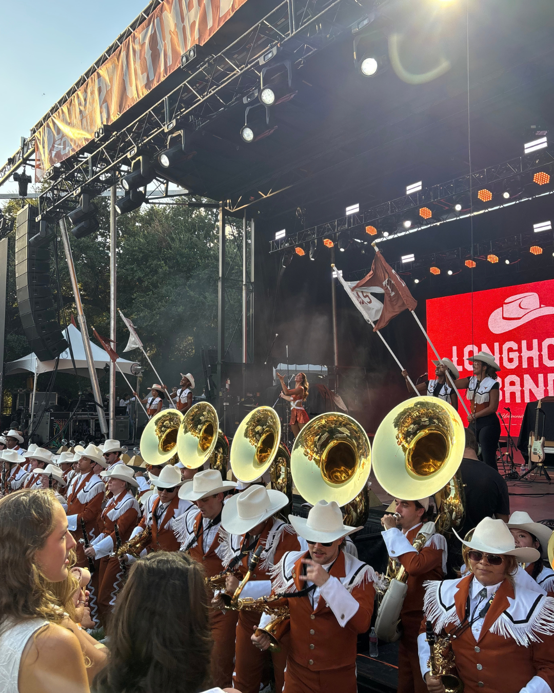 image of band members in front of a stage