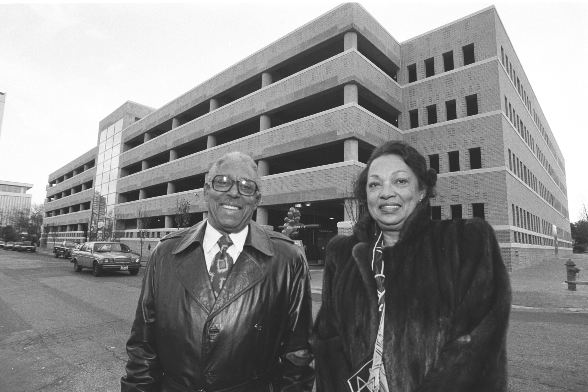 John and Drucie Chase in front of the San Antonio Garage that he designed on West Campus in 1994.