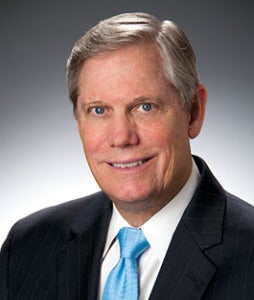 headshot of a man on a gray background 