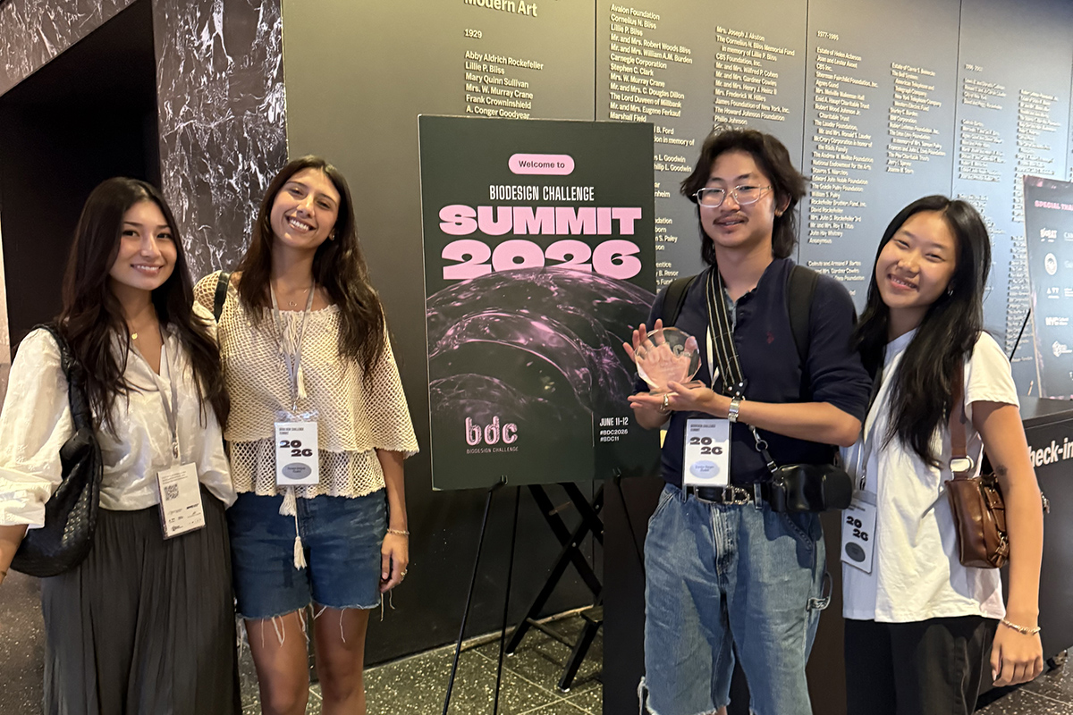 image of four students holding an award they won