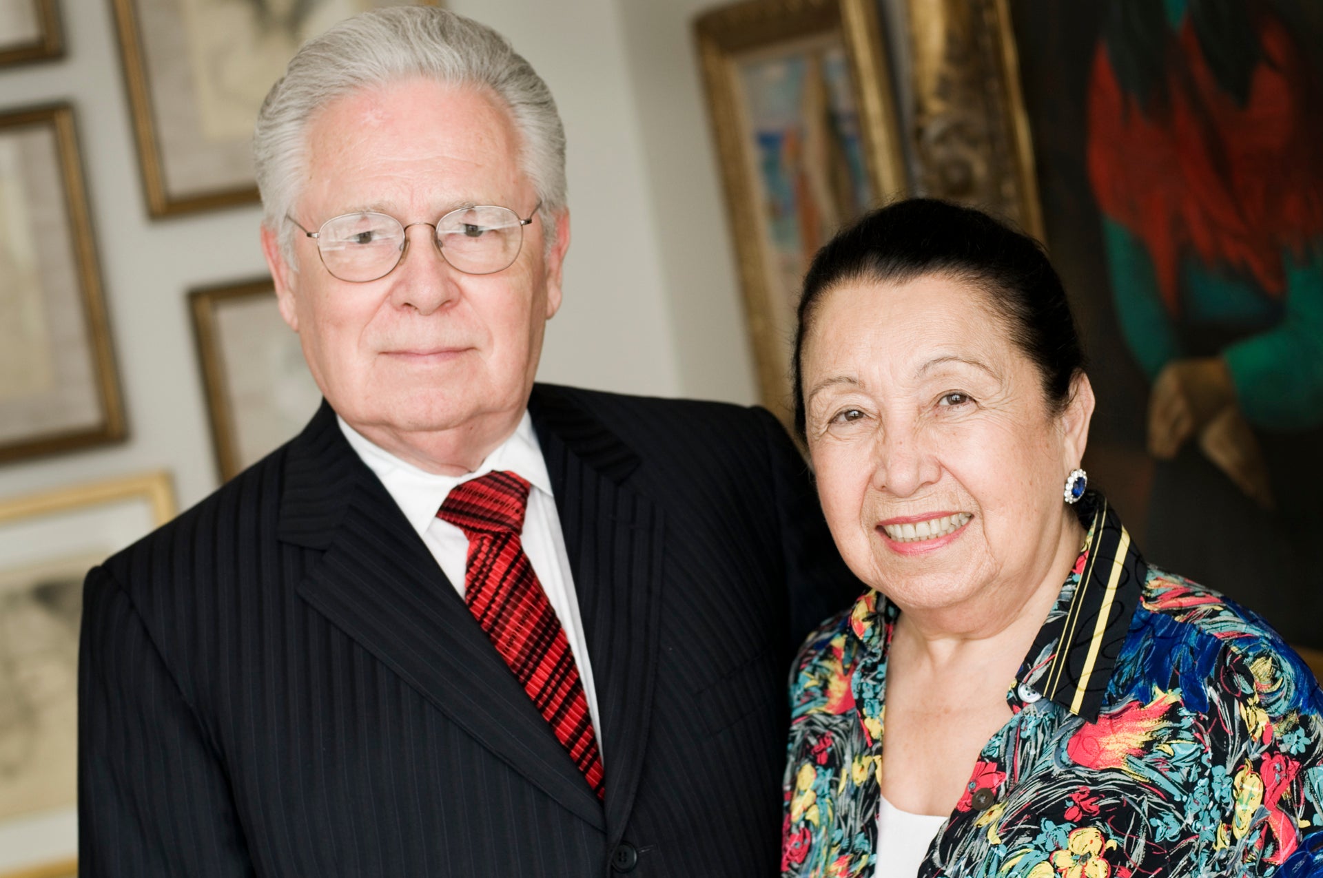 image of two people standing in front of a gallery wall