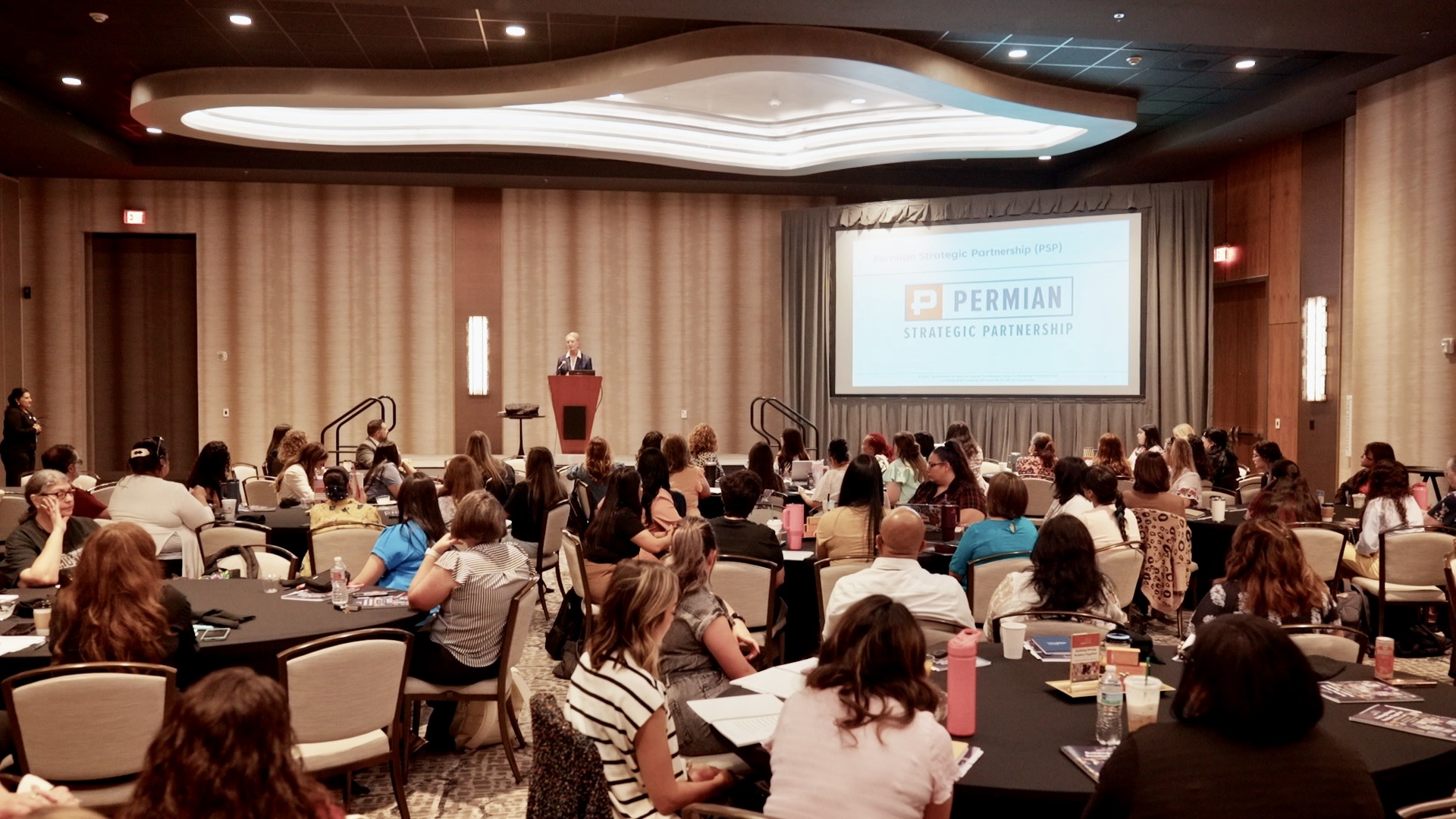 image of people sitting at tables at a conference