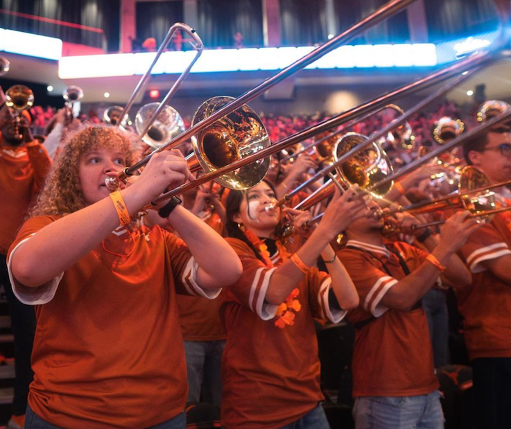 UT Band members play brass instruments in a line.