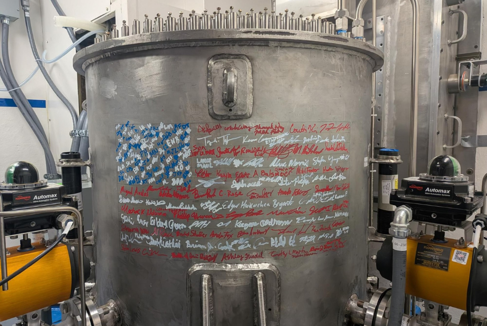 A nuclear reactor with signatures on it in the shape of an American flag.