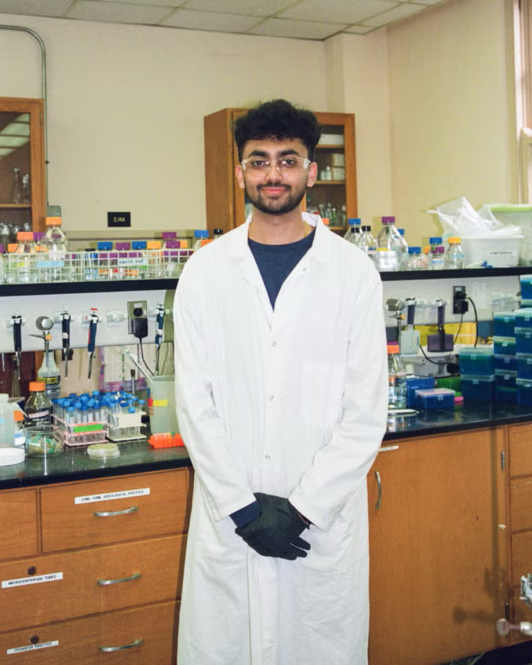 image of a student in a lab coat in the lab
