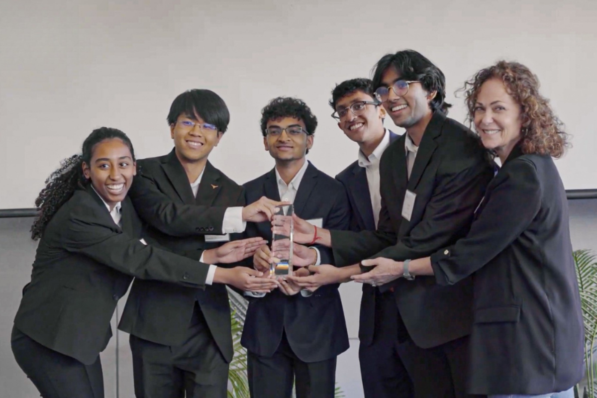 image of five students holding a trophy