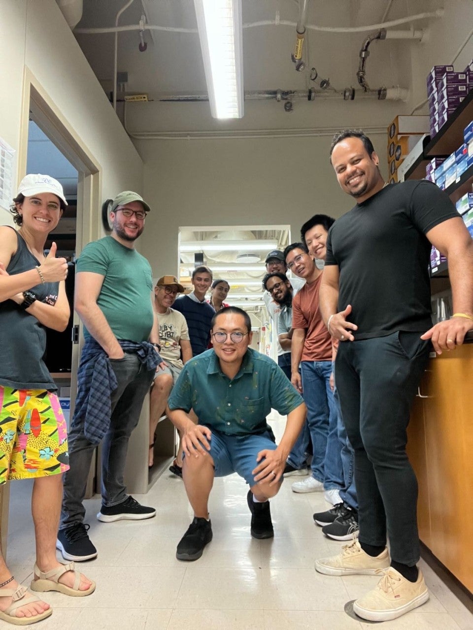 A group of people smile for a photo in a lab.