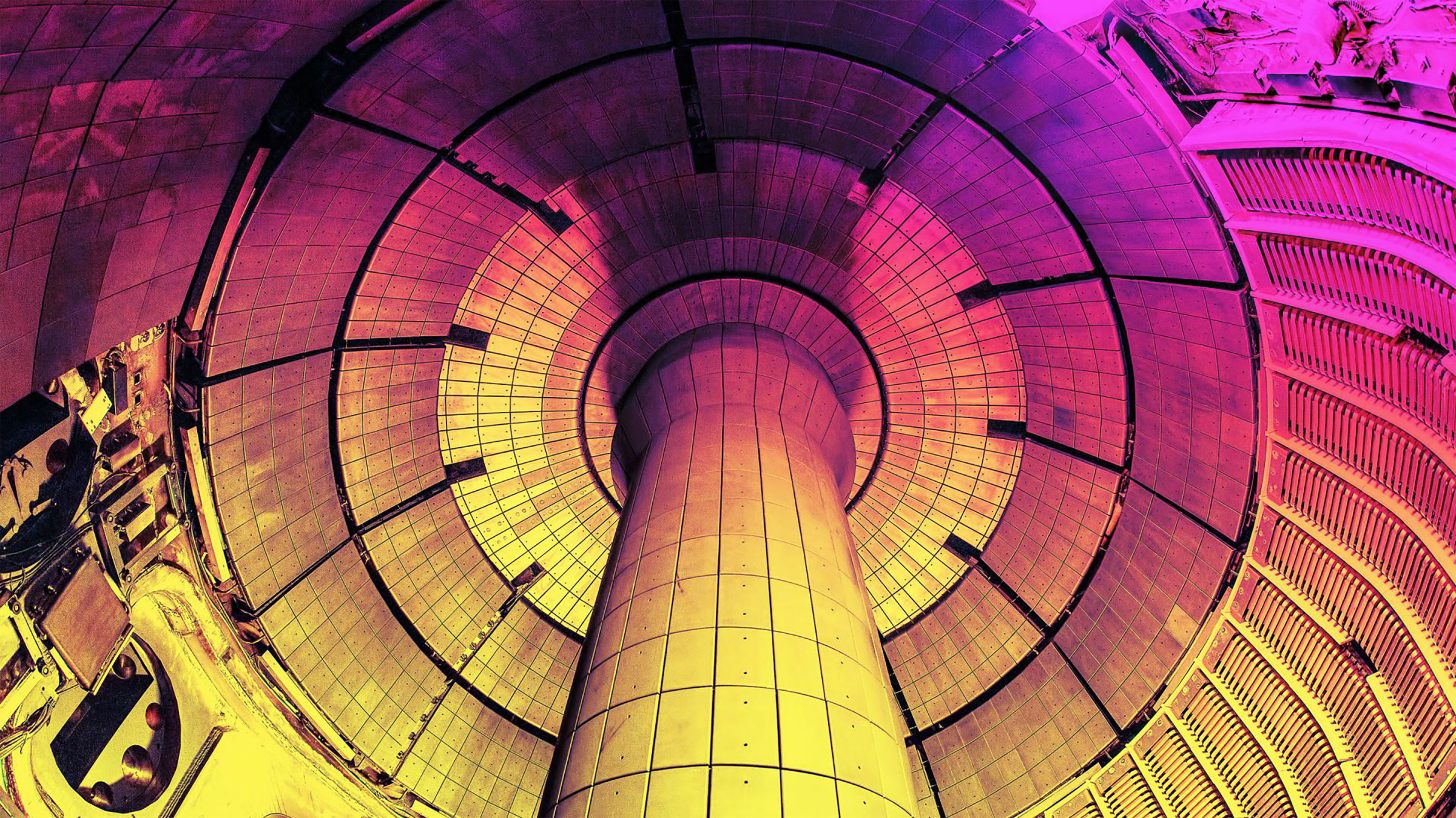 A colorized photograph of the inside of NSTX-U, an experimental fusion reactor that could be used to test liquid metal alloys